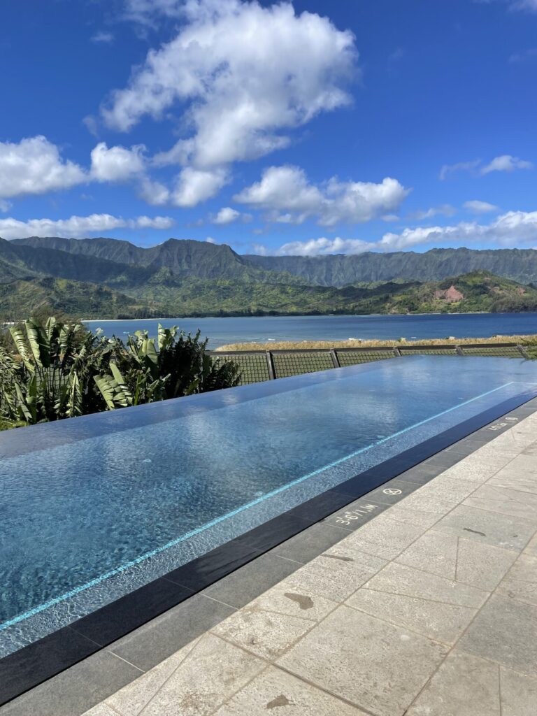 adult infinity pool at the 1 hotel Hanalei bay with mountains and ocean