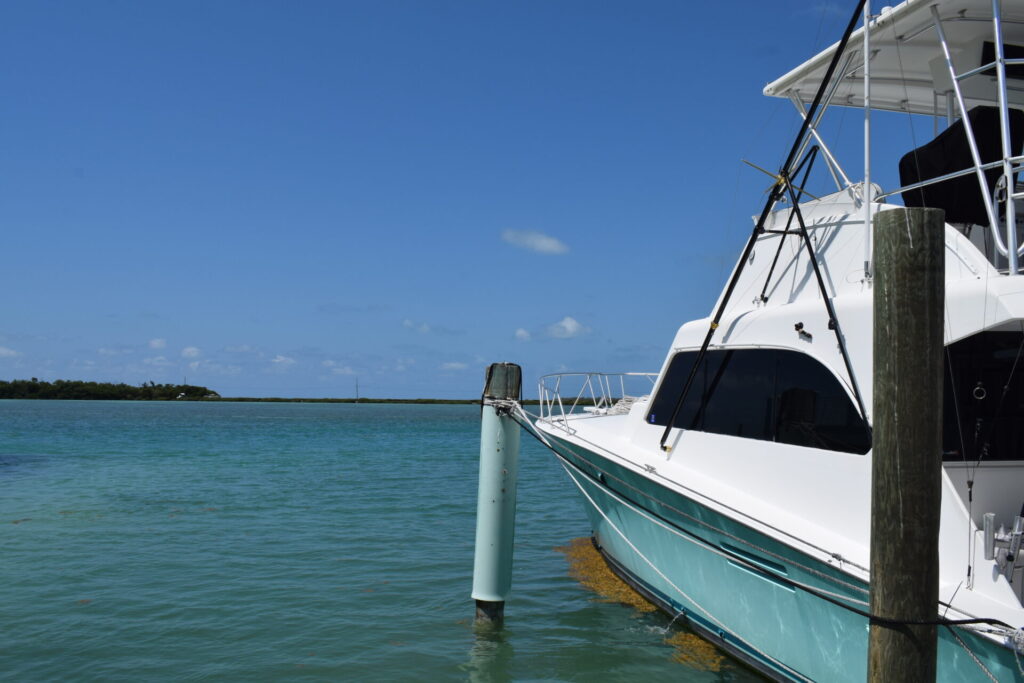 view of a boat at a marina in the florida keys, a vacation that can easily be booked on points.