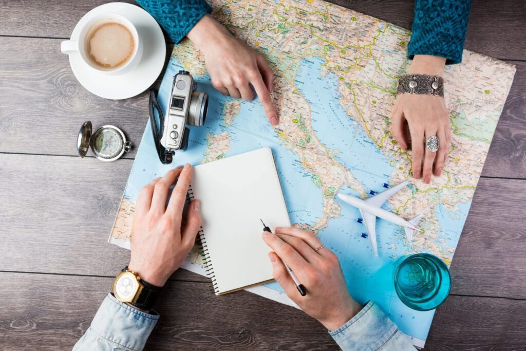 travel agents with map and coffee planning vacation